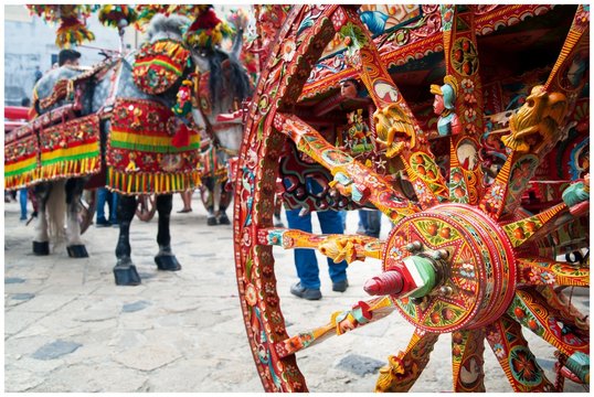 Close up view of a colorful wheel of a typical sicilian cart during a folkloristic show