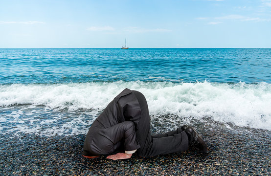 Businessman Burying His Head In The Ground