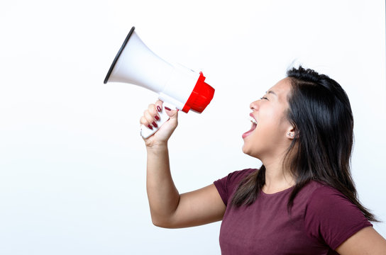 Young woman shouting into a megaphone