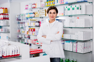 Female pharmacist arranging displayed assortment