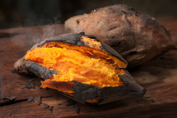 Delicious baked sweet potato on wooden table