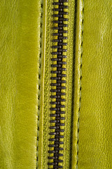 Green leather jacket zippers. Leather jacket macro details. Jacket zippers and pockets