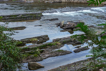 Stream Flowing Through Rocks in forest.