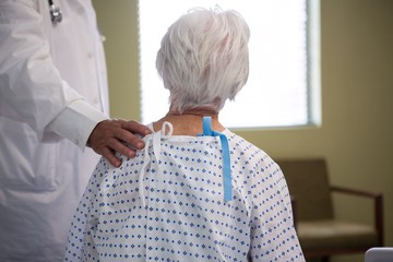Doctor consoling senior patient