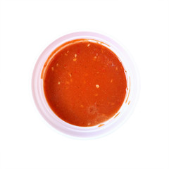 red suki sauce in circle bowl isolated on white