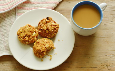 cereal cookie and coffee cup on wooden table