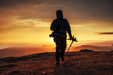 a tourist at sunset in the mountains