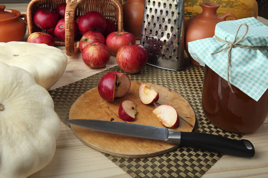 Patissons, apples, juice, honey, pumpkin on the desktop for cooking healthy diet. Retro stylized photo