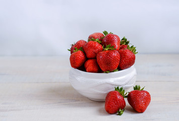 fresh sweet strawberry in the bowl on wooden background 
