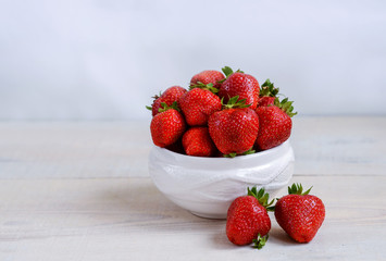 fresh sweet strawberry in the bowl on wooden background 