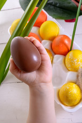 Child's hands holding chocolate Easter egg
