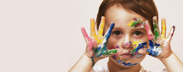 Colorful painted hands in a beautiful little child girl (art, childhood, colour concept)