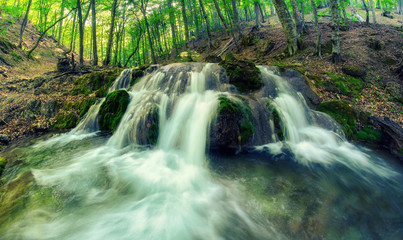 Mountain river on the two cascades with clear water.