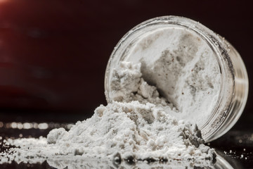 White powder scattered from a transparent jar