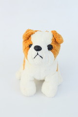 White dog doll with brown ears on white background.