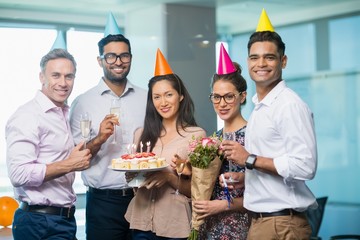 Portrait of smiling business colleagues celebrating birthday