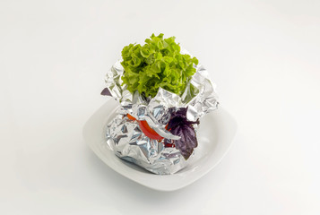 Meat with vegetables baked in aluminum foil