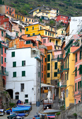 Fototapeta na wymiar Italy. Narrow streets of the fishing village of Riomaggiore on the coast of the Ligurian Sea. Unusual cityscape