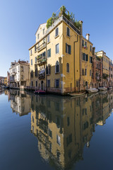Fototapeta na wymiar Beautiful reflections of the buildings in the Cannaregio district, Rio Priuli o de Santa Sofia and Rio Ca' Dolce, Venice, Italy