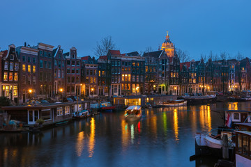Fototapeta na wymiar Canal in Amsterdam with houseboats in the evening, the Netherlands