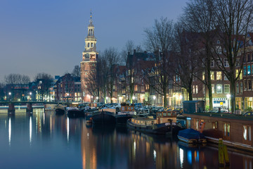 Embankment in Amsterdam with church in the blue evening light, the Netherlands