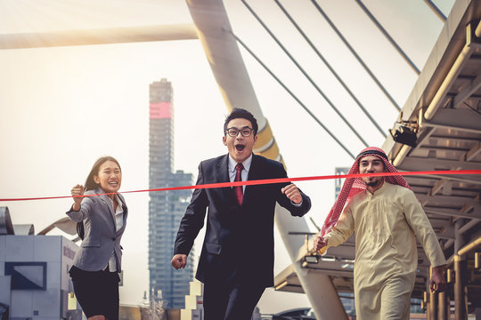 Businessman running to the finish line first with delight. Concept of competition in the race, running a business.