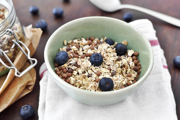 Delicious cereal breakfast with bowl and fresh fruits. Fresh blueberry fruits, healthy eating scene.