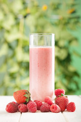 smoothie of berries on the table in the garden