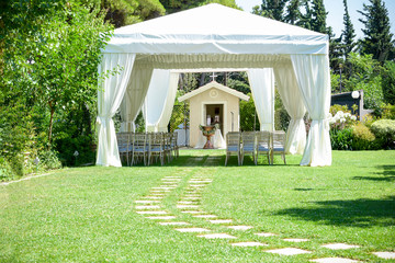 Decorative place for ceremonies or entertainments. Outdoor reception under tents and trees