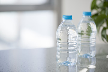 Water bottle with nature window in background.