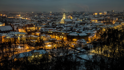 Aerial panorama of the Vilnius Old Town at dusk time. Night panorama of the Vilnius Old Town from the Hill of Three Crosses, Lithuania. Vilnius winter aerial panorama of Old town.