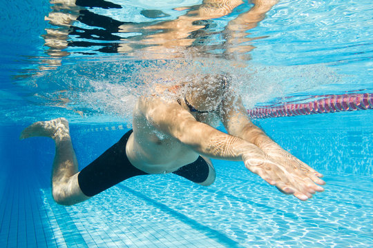Breaststroke swimming man under water