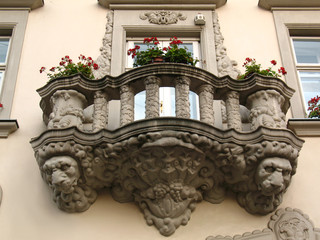 The view of vintage balcony with the heads of lions of the houses of old town in Lviv, Ukraine. Beautiful facade of a house. European culture and architecture