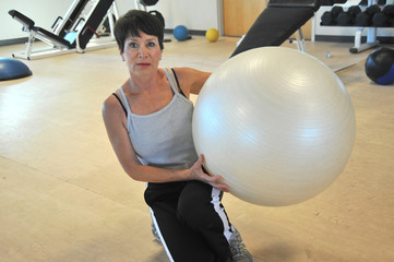 Mature female beauty working out inside a health club.