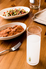 Turkish Drink Raki with acili ezme and gavurdagi salad with walnut. 