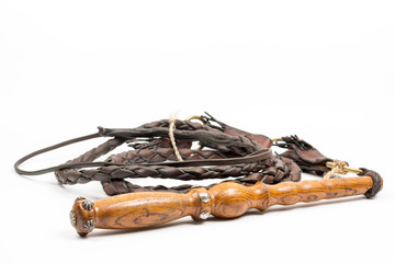 Leather whip isolated over white background closeup macro