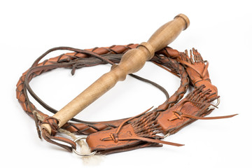 Leather whip isolated over white background closeup macro