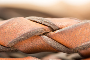 Leather whip isolated over white background closeup macro