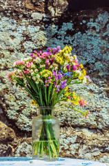 Beautiful colorful bunch of fresh flowers in glass jar