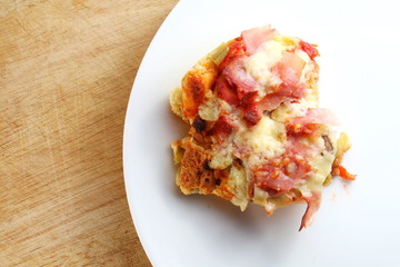 A homemade Italian style pizza on the white dish.