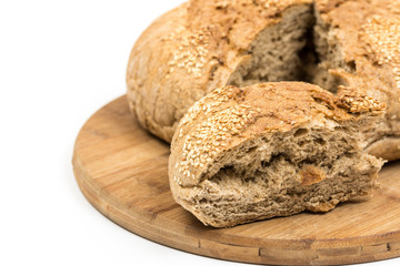 Round domestic bread sliced on the wooden board