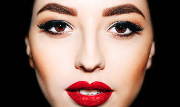 sexy woman with red lips and bright eyelashes makeup