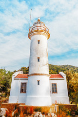 Lighthouse at Gelidonya cape, coastline of Mediterranean sea, Turkey. Location nearby Kanaoz, Kemer and Antalya turkish resort city. Famous travel destination. Vertical orientation.