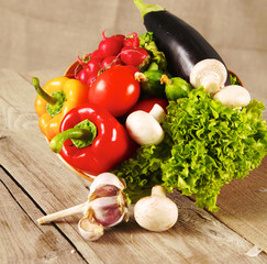 Composition with assorted raw organic vegetables wooden table