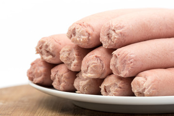 Cooked hot dogs served on the plate over white background