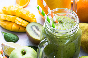 Green and yellow smoothie in mason jar