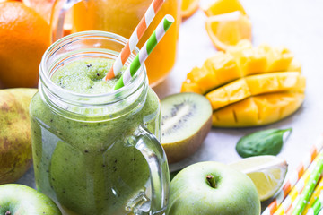 Green and yellow smoothie in mason jar