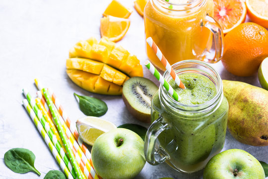 Green and yellow smoothie in mason jar. Mango and spinash drinks. Healthy food and diet.