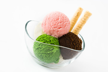 Ice cream scoops in crystal bowl, isolated on white background. Copyspace.
