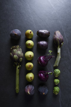 Seasonal vegetables and fruits, artichokes, pears, figs, raves, violet potatoes and Brussels sprouts to cook for a slimming and detox recipe